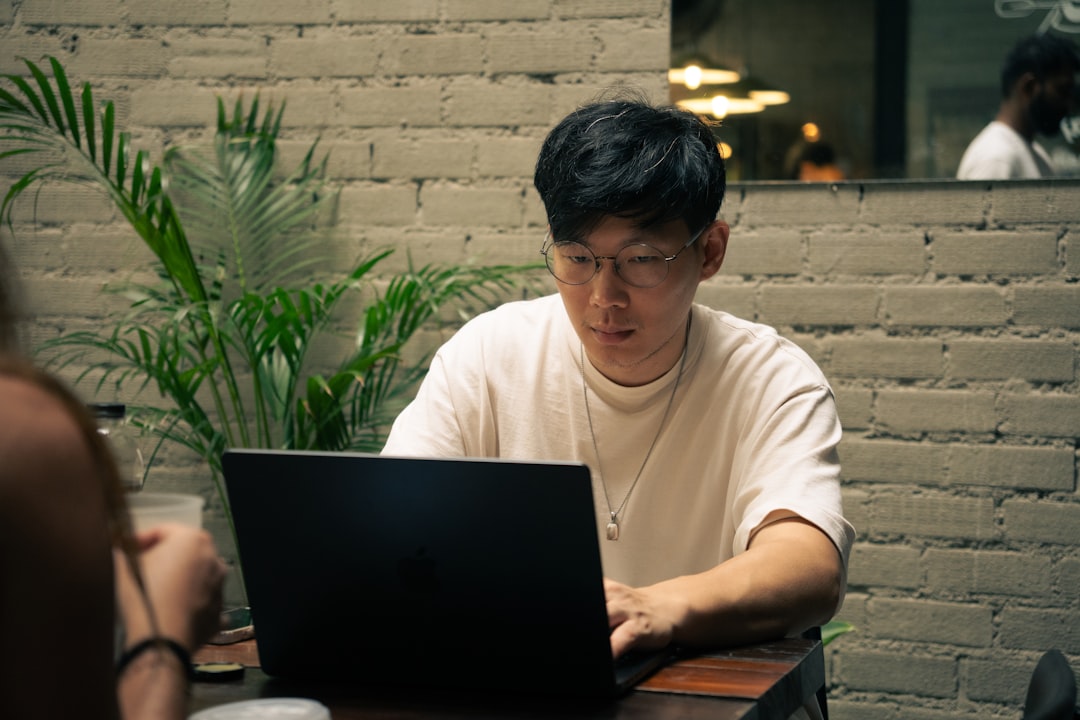japanese man working laptop cafe evening