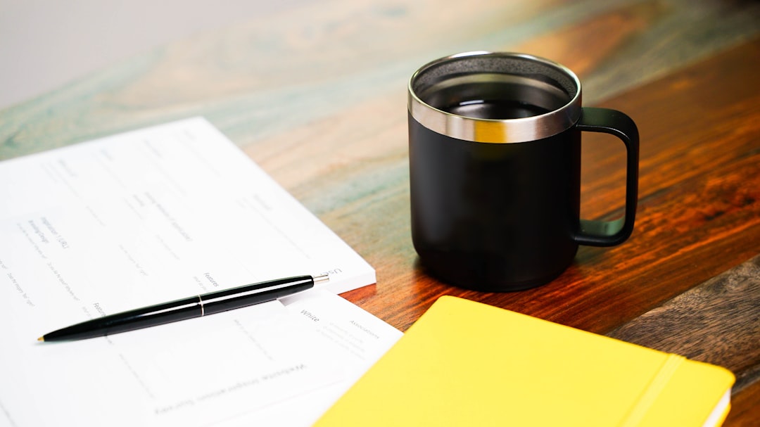 checklist notebook and coffee on desk