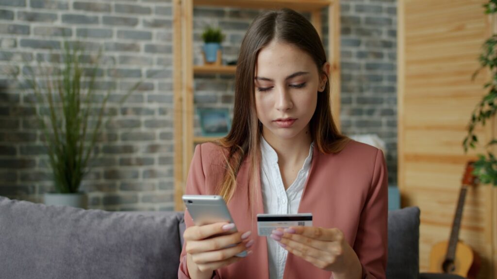 woman calculating budget smartphone home night