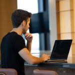man working laptop presentation slides desk