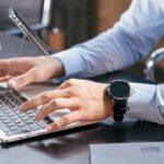 businessman reading job reviews on laptop