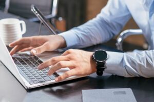 businessman reading job reviews on laptop