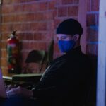 engineer working remotely on laptop at night