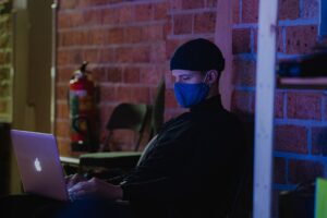 engineer working remotely on laptop at night