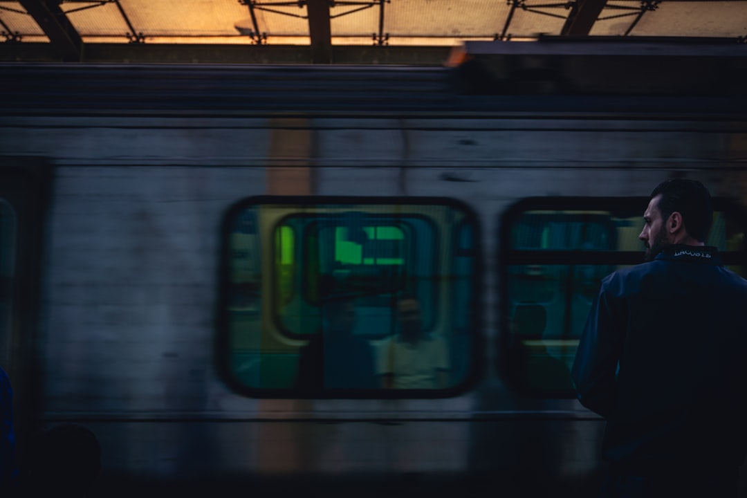 businessman looking at smartphone on evening train