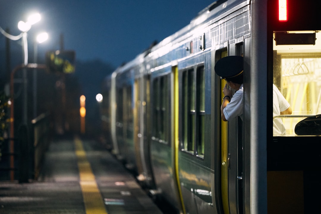 businessman looking at smartphone on evening train