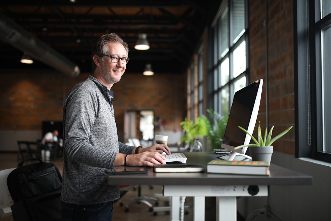 confident engineer smiling at desk