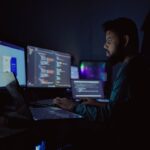tired engineer working late at night computer screens