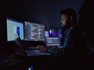 tired engineer working late at night computer screens