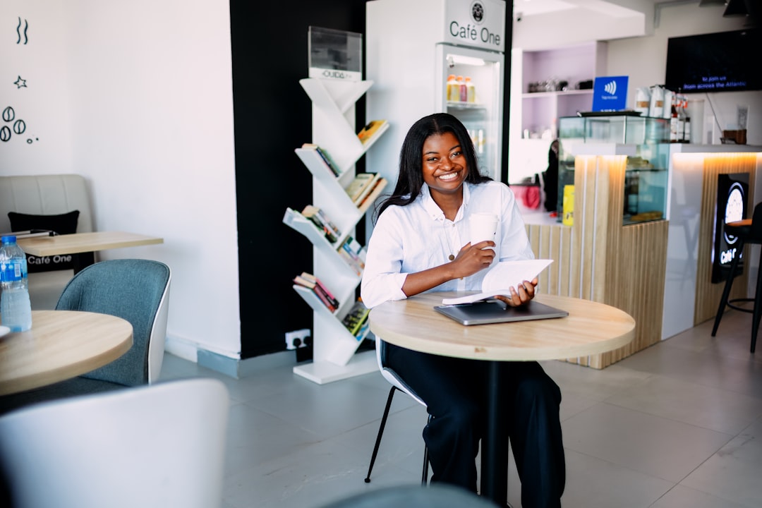 woman writing career notes in cafe