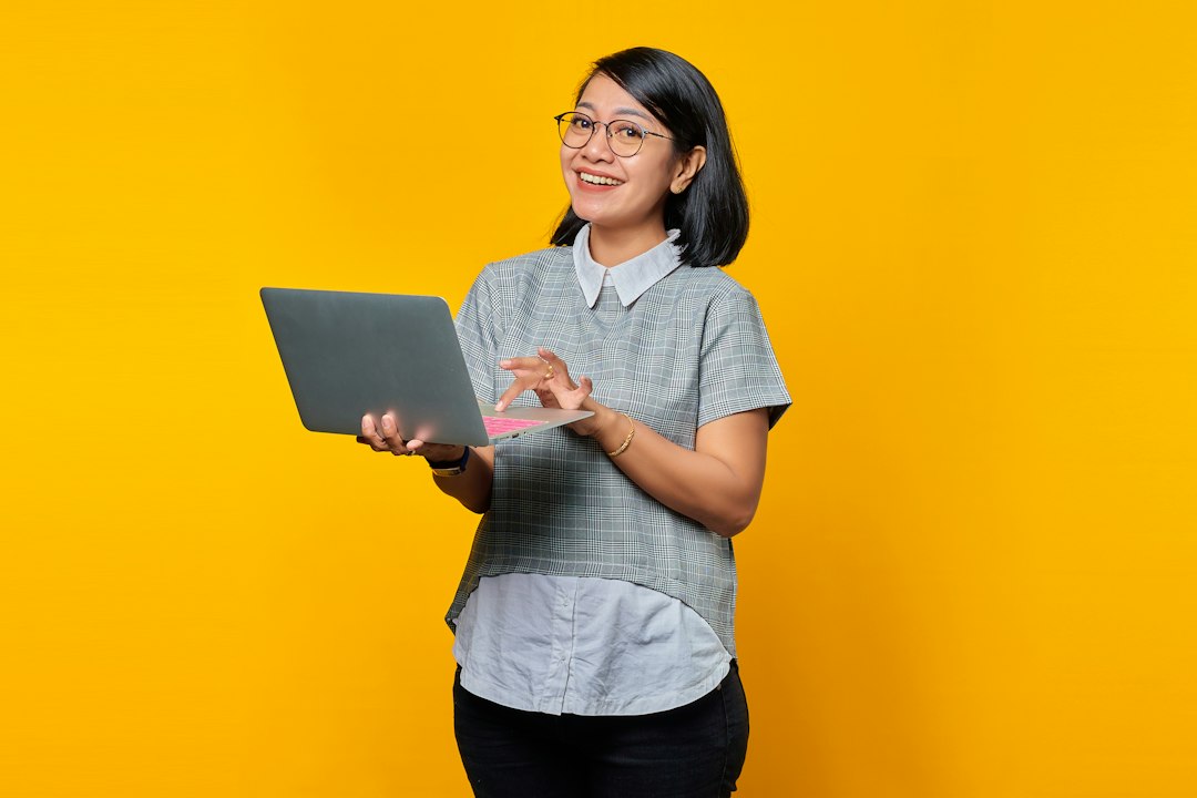 confident software engineer freelancer smiling with laptop