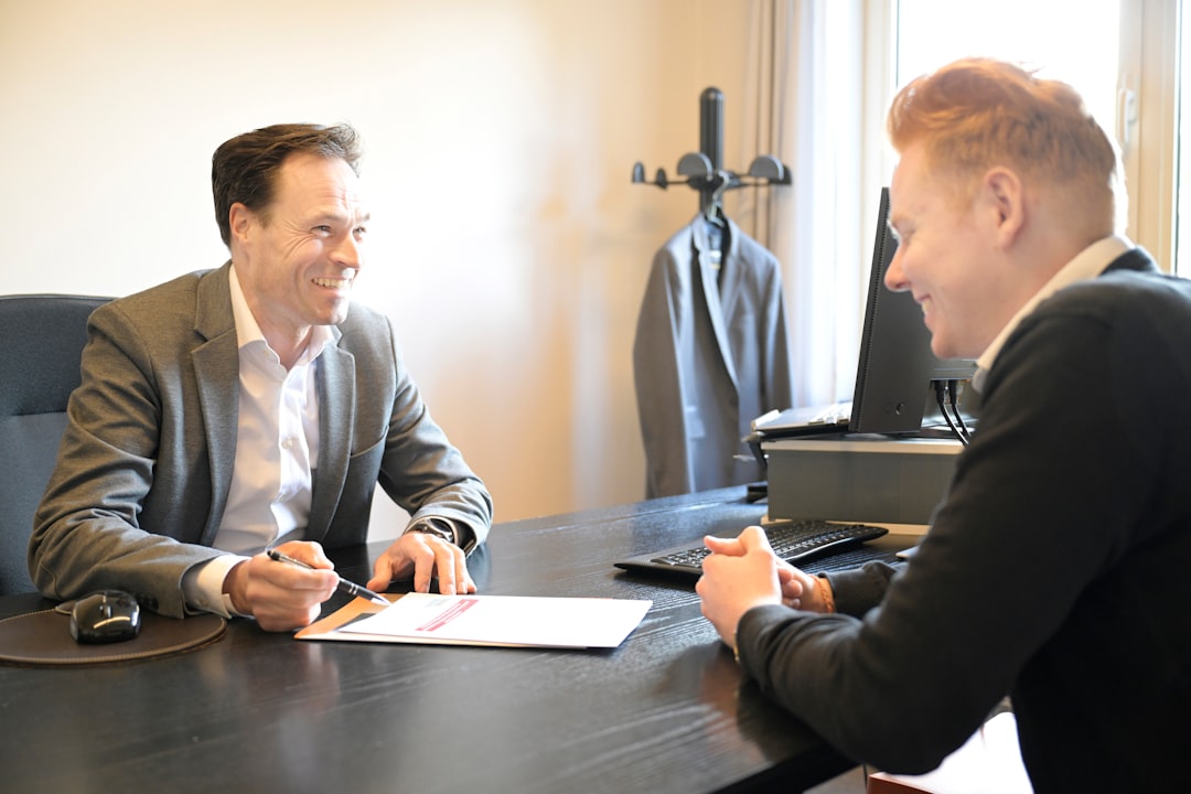 two people discussing at desk consultation