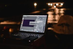 freelance developer working alone at night laptop