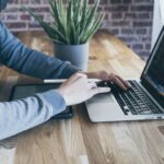 software tester working on laptop