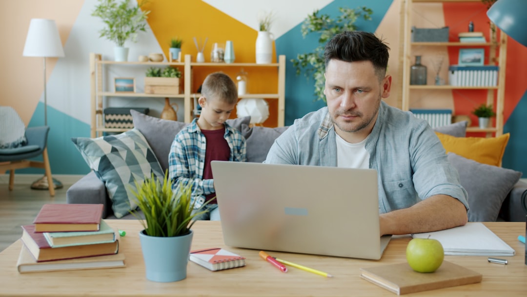 father working from home with family