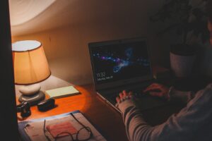 man studying web marketing laptop night