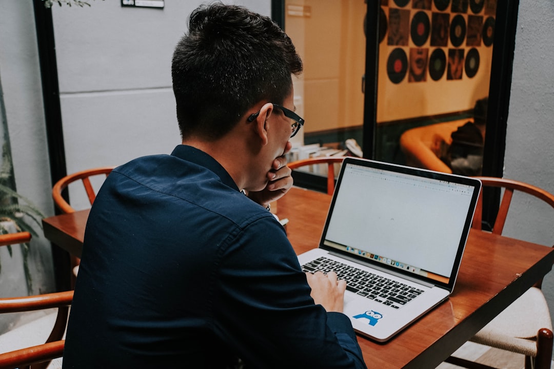 person reviewing job listing on laptop
