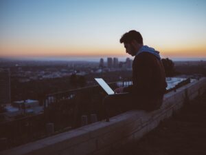 man studying cloud computing laptop night