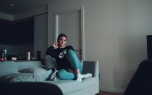 woman using smartphone on sofa at night