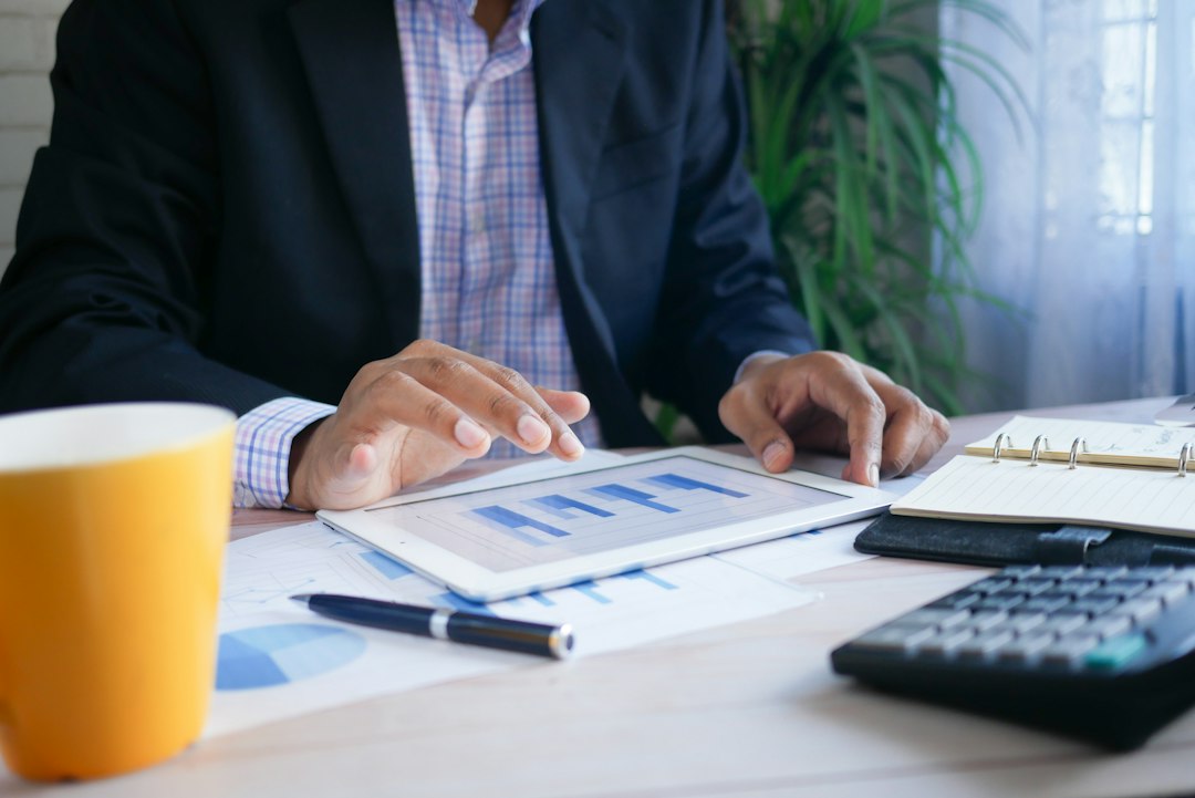 man reviewing salary chart on desk