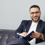 businessman writing career plan notebook