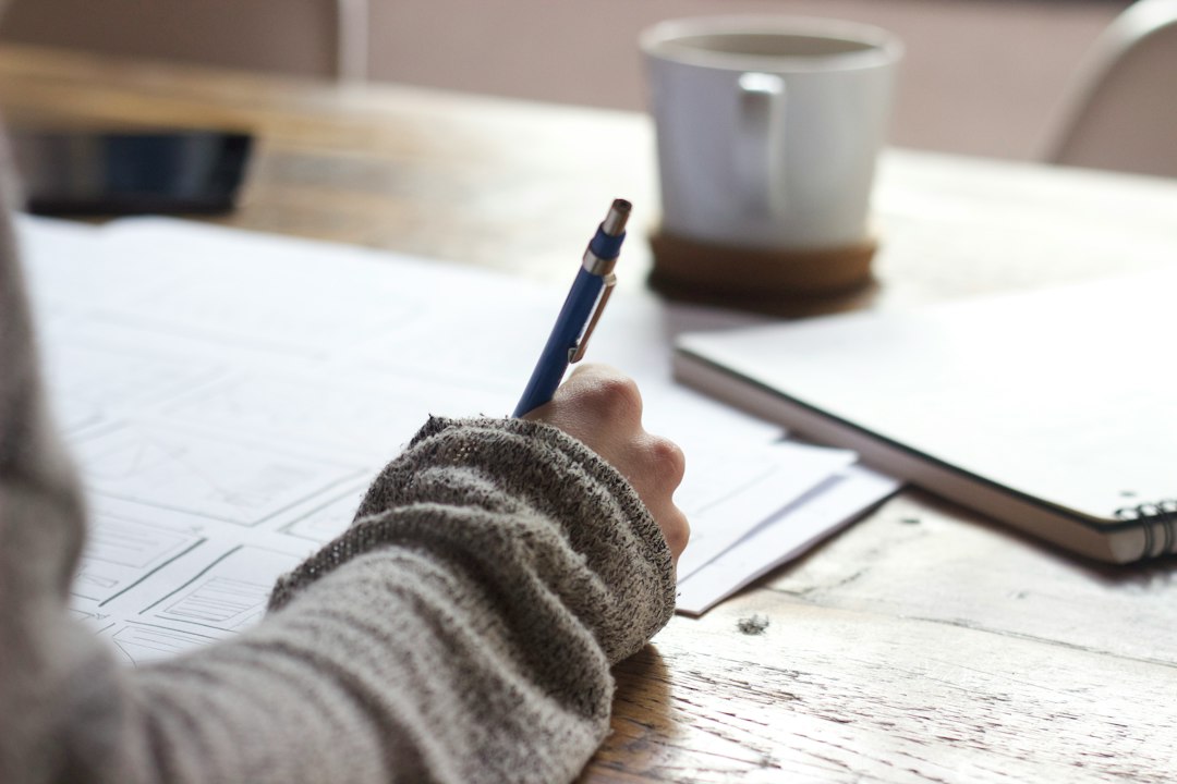 person writing notebook planning career