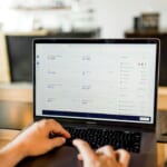 person entering receipts into accounting software laptop